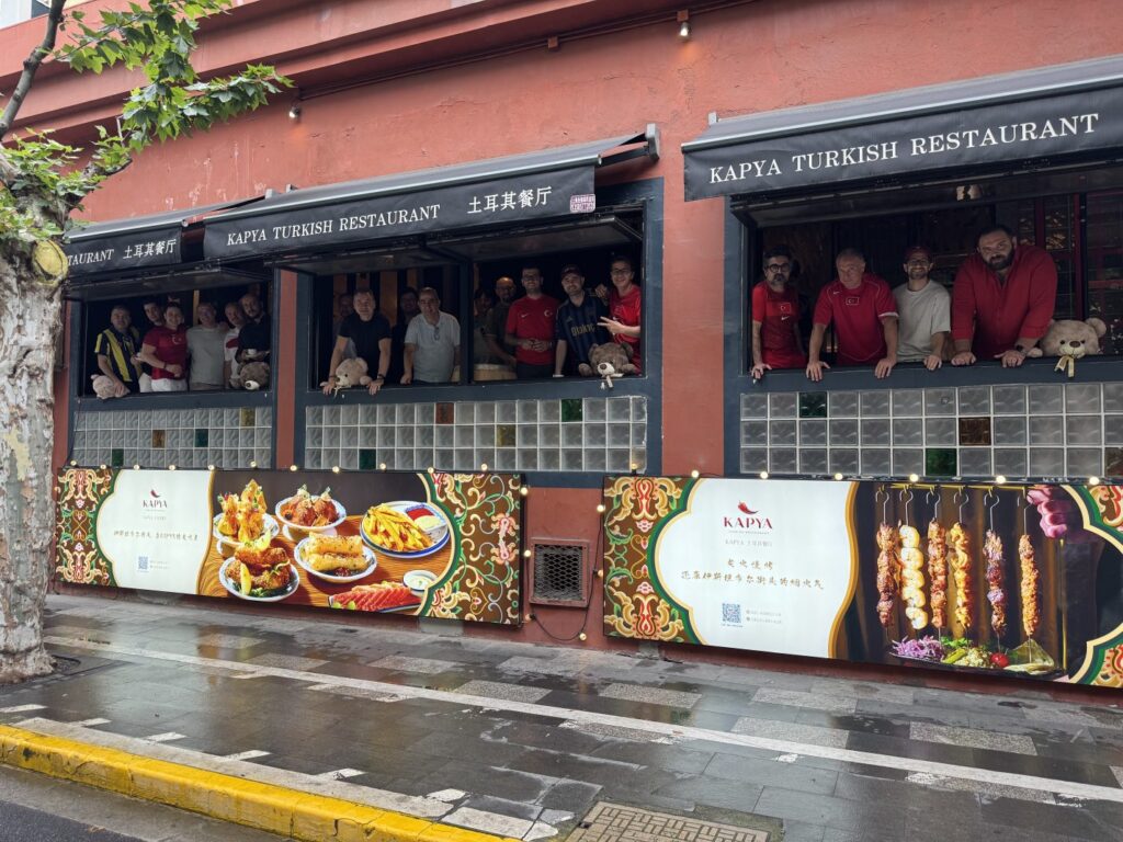 World Cup 2026 watch party at KAPYA Turkish Restaurant in Shanghai – football fans cheering at live match with Turkish food on the table