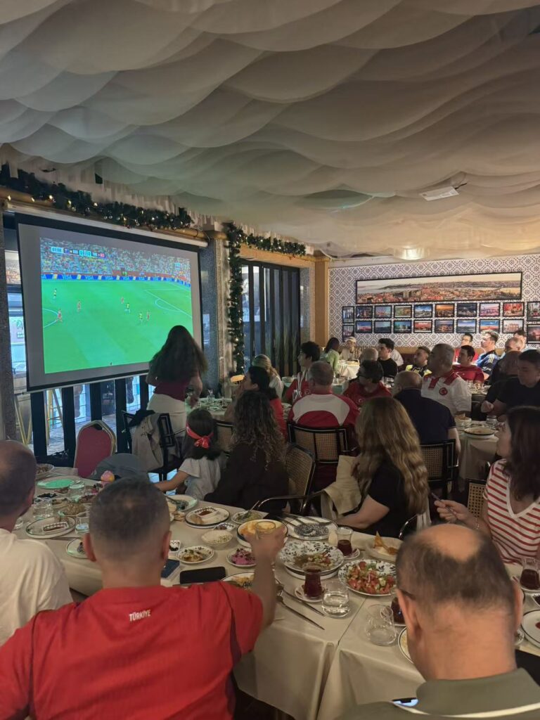 World Cup 2026 watch party at KAPYA Turkish Restaurant in Shanghai – football fans cheering at live match with Turkish food on the table